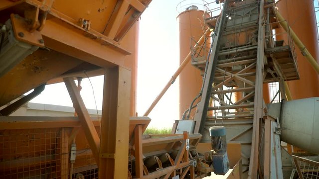 Automatic transport of ingredients to concrete mixer. The process of making concrete. How concrete is done.