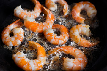 fried shrimp in a pan in oil, cooking