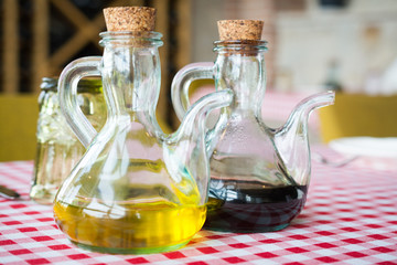bottle of olive oil and a bottle of balsamic vinegar on a table