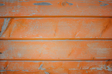 Background of orange flaky wood Backdrop of red colored wooden panels with aged flaky surface	