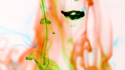 Slow motion abstract flow of green and orange drops of color swirling and combining together - Powered by Adobe