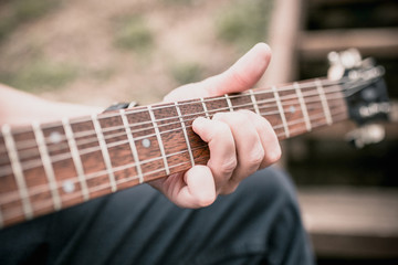 Technique of playing the electric guitar - a man playing outdoors - heavy hard rock and blues music