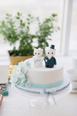 wedding cake with figures of the bride and groom close-up on the wedding table