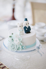 wedding cake with figures of the bride and groom close-up on the wedding table