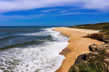 View of empty long Nazare North beach from Nazare. Atlantic Ocean, Portugal