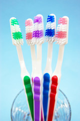 Toothbrushes in a glass, blue background