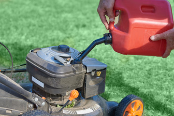 The process of refueling of lawn mower.