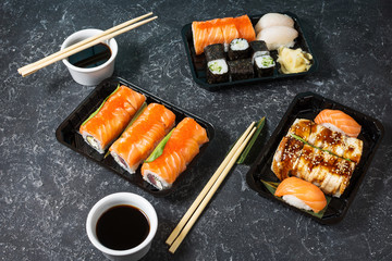 Various kinds of sushi served on stone background.