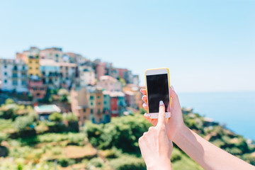 Closeup of smartphone background of old italian village in Man hands