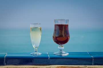 Two glasses of wine on the balcony of the luxurious hotel, illustrating wonderful vacations.