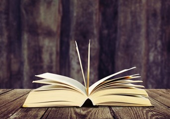 Open book on old wooden table