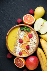 Fototapeta na wymiar Smoothie bowls. Healthy breakfast bowl with chia seeds, muesli, berries, fruits and coconut flakes coconut flakes. Vegan food