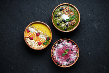 Smoothie bowls. Healthy breakfast bowl with chia seeds, muesli, berries, fruits and coconut flakes coconut flakes. Vegan food