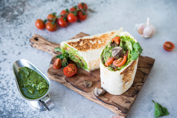 Burrito wraps with vegetables and sauce pesto.Roll with vegetables, mushrooms and pesto sauce. Vegetarian kebab. Of diet food.