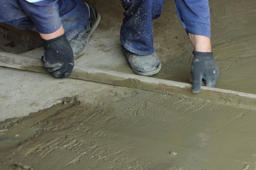 Work aligns wooden rail concrete self-leveling floor