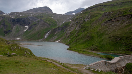 Mountain lake grass snow clouds