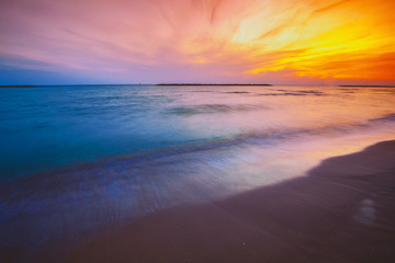 Fototapeta na wymiar Seashore in the evening. Sunset over the sea. Beautiful beach with dramatic sunset sky