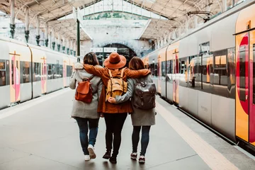 Foto op Canvas .A group of young friends waiting relaxed and carefree at the station in Porto, Portugal before catching a train. Travel photography. Lifestyle. © lubero