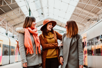 .A group of young friends waiting relaxed and carefree at the station in Porto, Portugal before catching a train. Travel photography. Lifestyle.