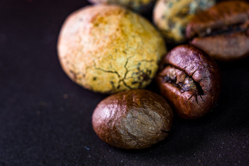 Brown roasted coffee and cocoa beans on black background, close up, macro