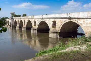 Fototapeta na wymiar Medieval Bridge from period of Ottoman Empire over Meric River in city of Edirne, East Thrace, Turkey