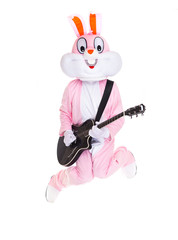 Man in a easter bunny costume plays music on guitar, jumps, have fun on white background. Funny...