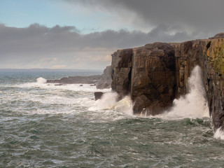 Atlantic ocean, West coast of Ireland, Mini cliff, county Clare, Cloudy day, Wave hits stone cliff.