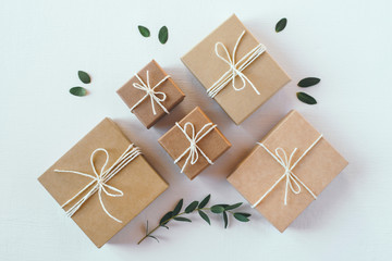 Craft gift boxes on white wooden background. Flat lay