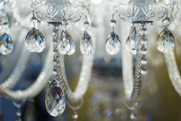 Detail design and interior lighting - white metal lamp in the form of candlesticks and candles.