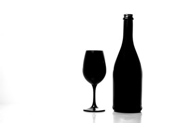 Black champagne bottle with black champagne glass isolated on white background