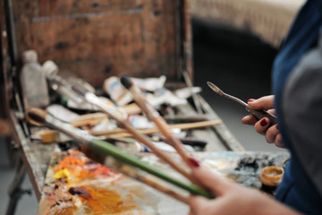 Brushes in the hands of the artist's women. Drawing and art.