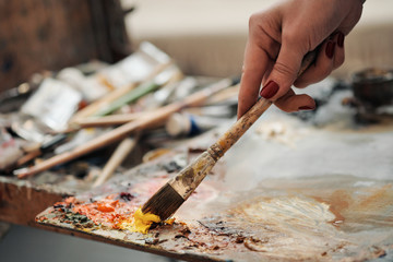 Brushes in the hands of the artist's women. Drawing and art.