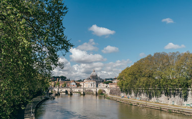 Fototapeta na wymiar Tiber river cityscape in the Rome city centre with St. Peter's Basilica (Vatican) on the background.
