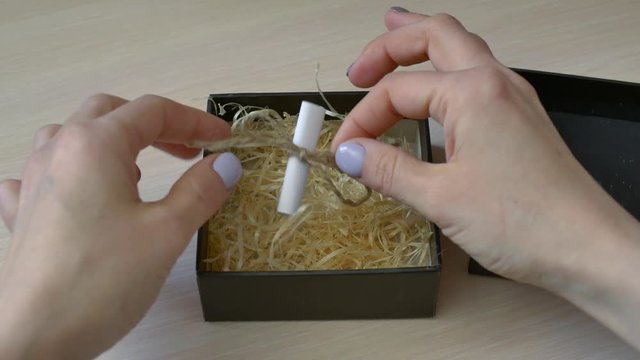motivational message "keep moving" in a note tied with a rope, in a gift box