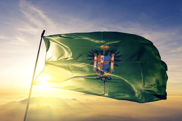 Toledo province of Spain flag waving on the top sunrise mist fog