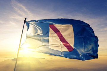 Campania region of Italy flag waving on the top sunrise mist fog