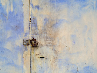 Old metal doors are stained with rust.