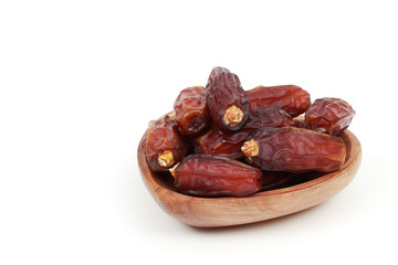Islamic festival of Ramadan concept. with a delicious tropical dates on a bamboo plate and on white isolated background. Traditional Middle East culture. Ramadan Kareem.