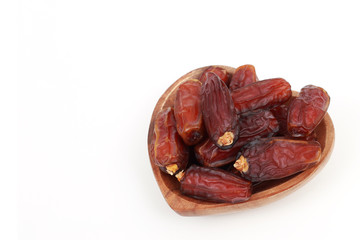 Islamic festival of Ramadan concept. with a delicious tropical dates on a bamboo plate and on white isolated background. Traditional Middle East culture. Ramadan Kareem.