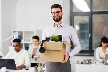 business, new job and quit concept - happy smiling male office worker with personal stuff