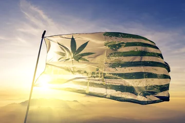 Fotobehang USA flag paint weed mariguana marijuana flag waving on the top sunrise mist fog © Oleksii