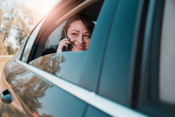 Powerful businesswoman using mobile phone in a backseat os a limousine