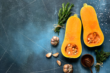 Halves of raw organic butternut squash with ingredients for making . Top view with copy space. - Powered by Adobe
