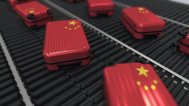 Suitcases featuring flag of China move on the conveyor in an airport. Chinese tourism related loopable animation