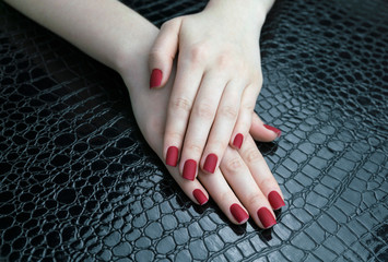 Stylish fashionable female red matte manicure, square shape