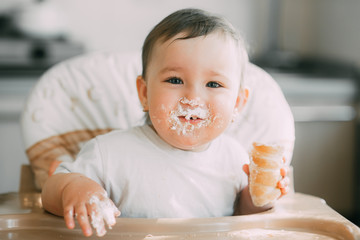 baby in the kitchen eagerly eating the delicious cream horns, filled with a vanilla cream