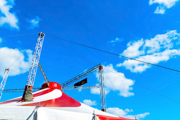 Circus tent under the blue cloudy sky