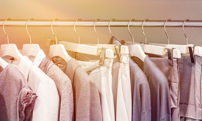 Modern clothes on metal hangers in closet