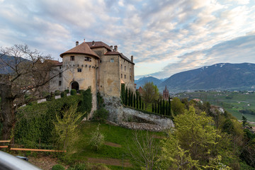 Naklejka premium Panoramic view on Castle Schenna (Scena) near Meran during sunset. Schenna, Province Bolzano, South Tyrol, Italy.