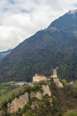 Fototapeta na wymiar Tyrol Castle in landscape of high mountains. Tirol Village, Province Bolzano, South Tyrol, Italy.